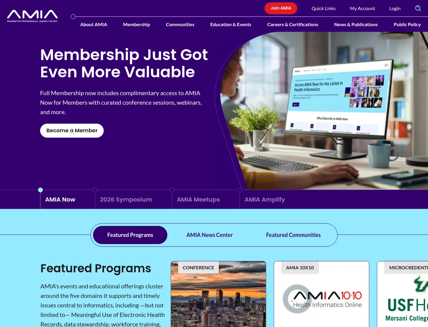The AMIA homepage, showing a membership promotion, a row of tabs for AMIA Now, the 2026 Symposium, Meetups and Amplify, and a Featured Programs carousel of courses and conferences